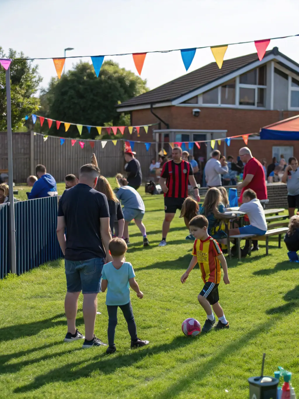 A photo of a community event organized by FOOTBALL CLUB DE MONTENDRE, showing families and supporters enjoying a day of football-related activities and games.